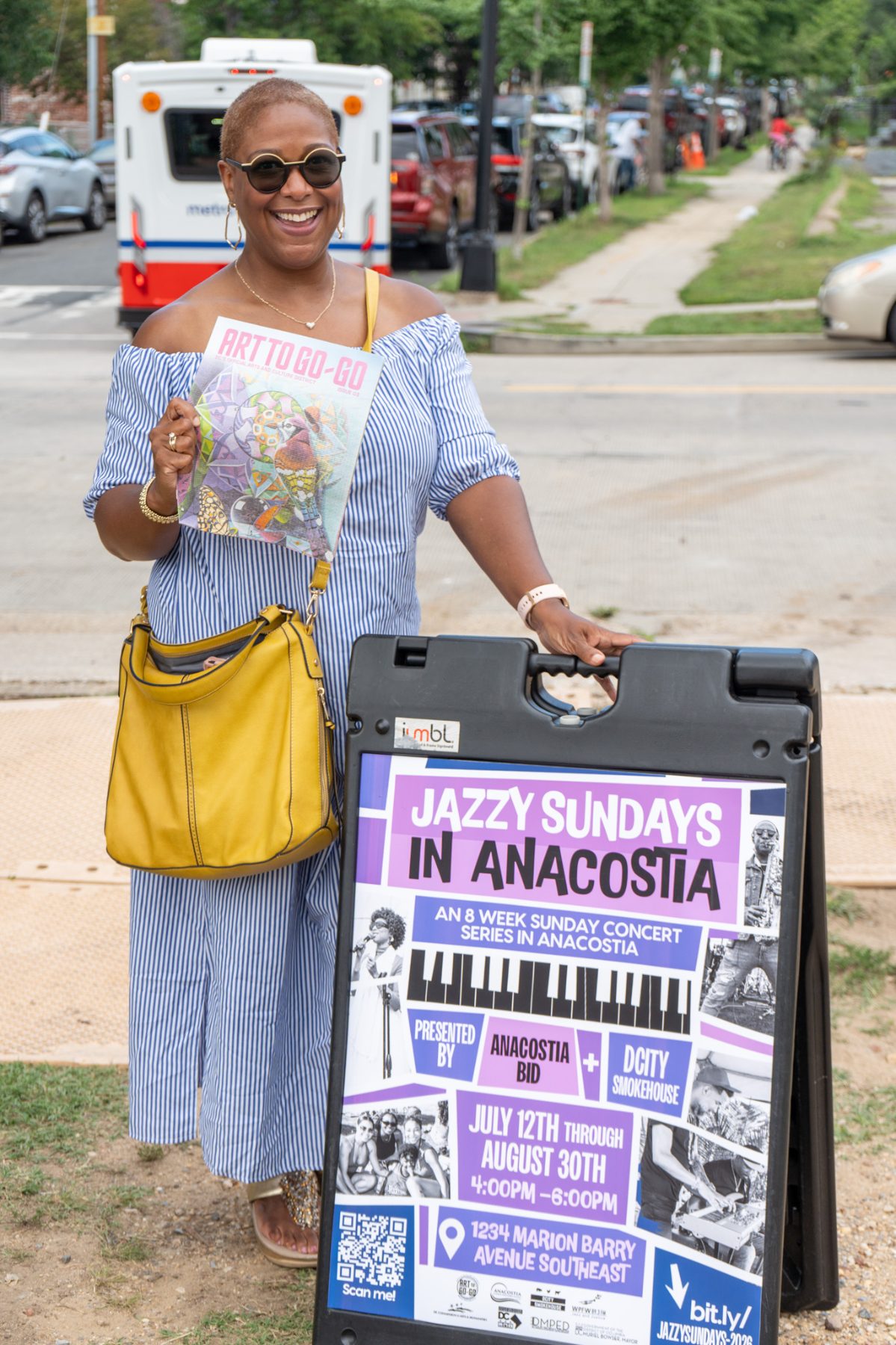 Culture Woman holding art to go go Jazzy Sundays